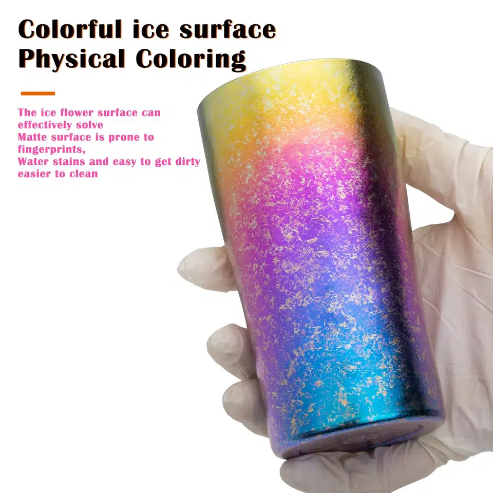 A hand wearing a rubber glove is holding a cup made of titanium alloy with rainbow-colored frost patterns on it..